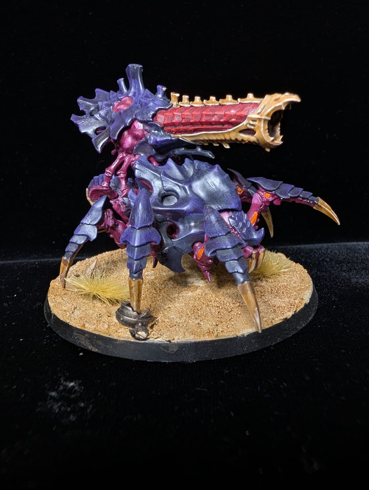 Tyranid Biovore in purple and pink carapace with bone spikes, on a sandy base