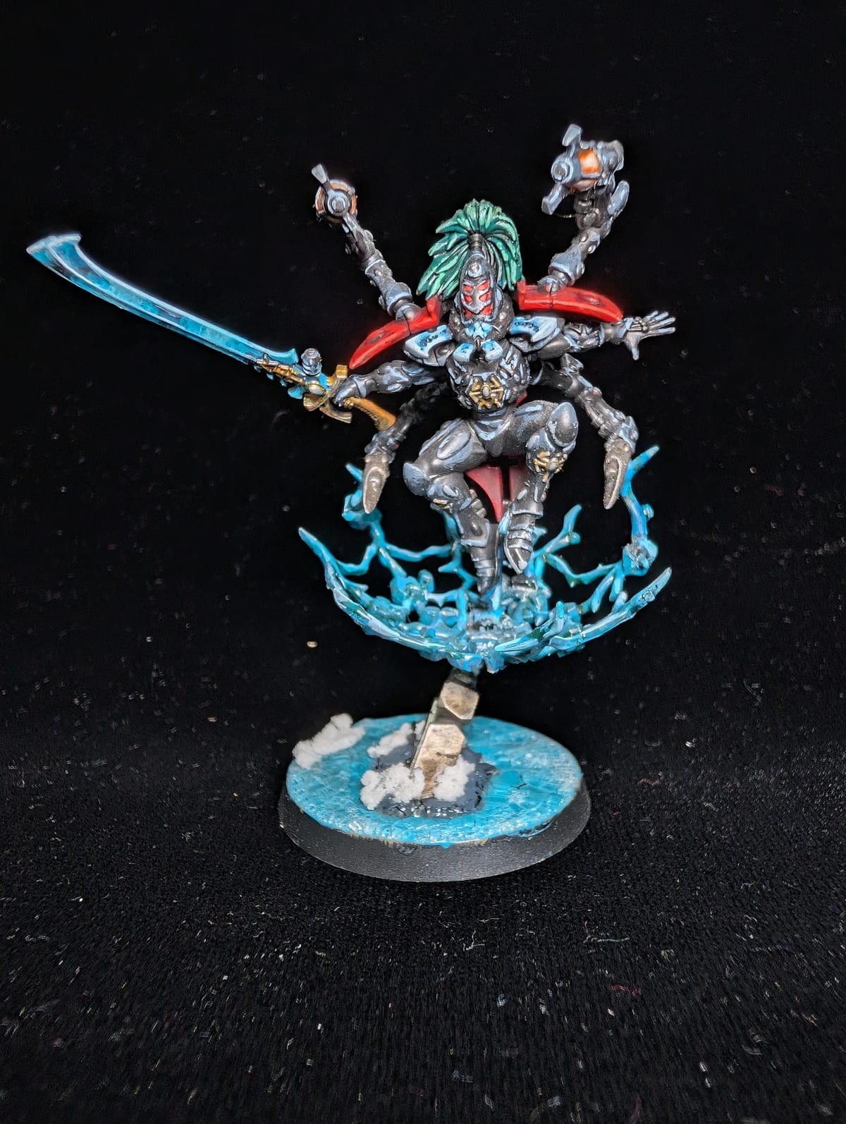 Aeldari Phoenix Lord Lhykhis with a sword and teal hair, leaping across a wave of turquoise ice