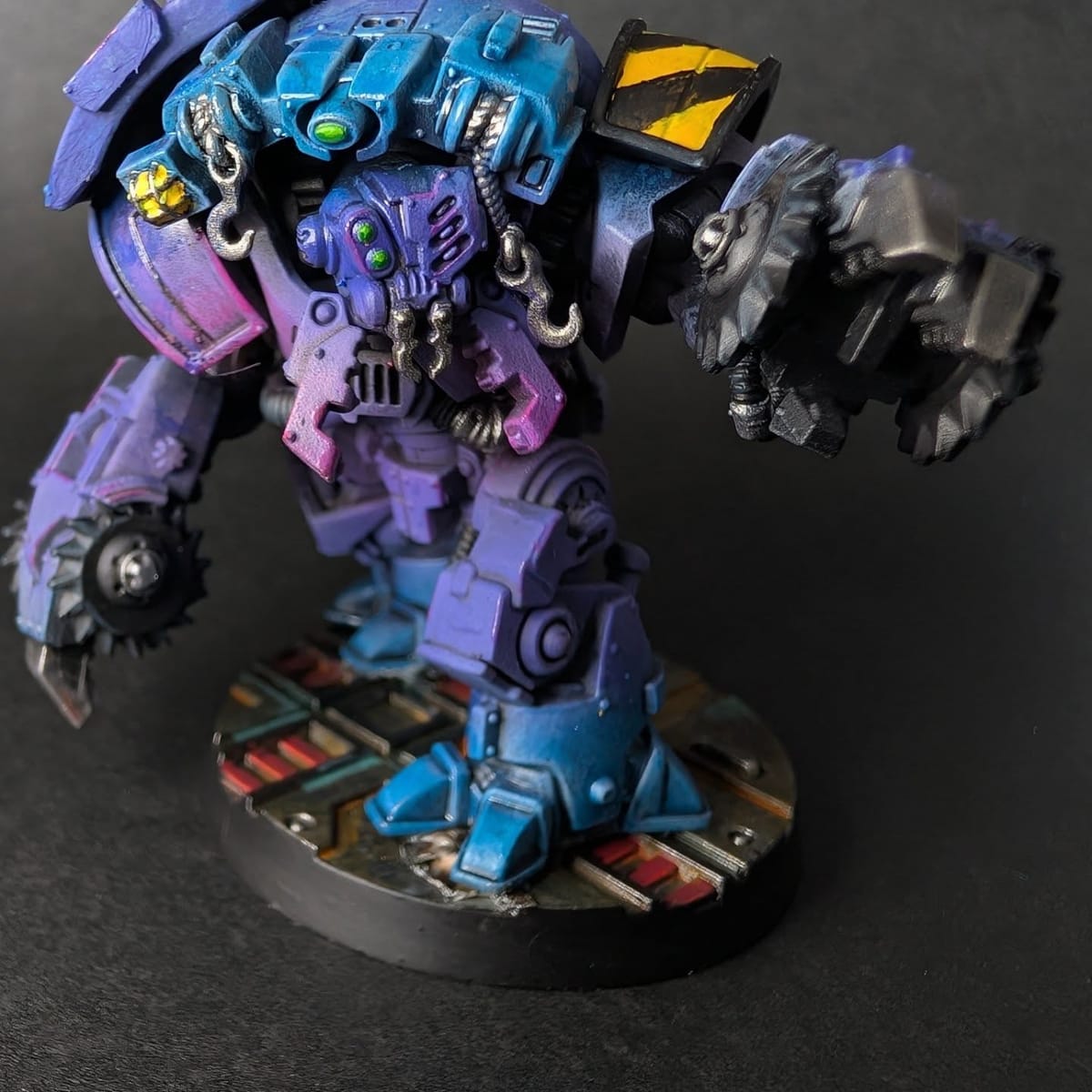 Large walker miniature painted in a purple and cyan gradient scheme with hazard stripes